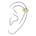 Gold earring worn on a black line drawing of an ear against a white background