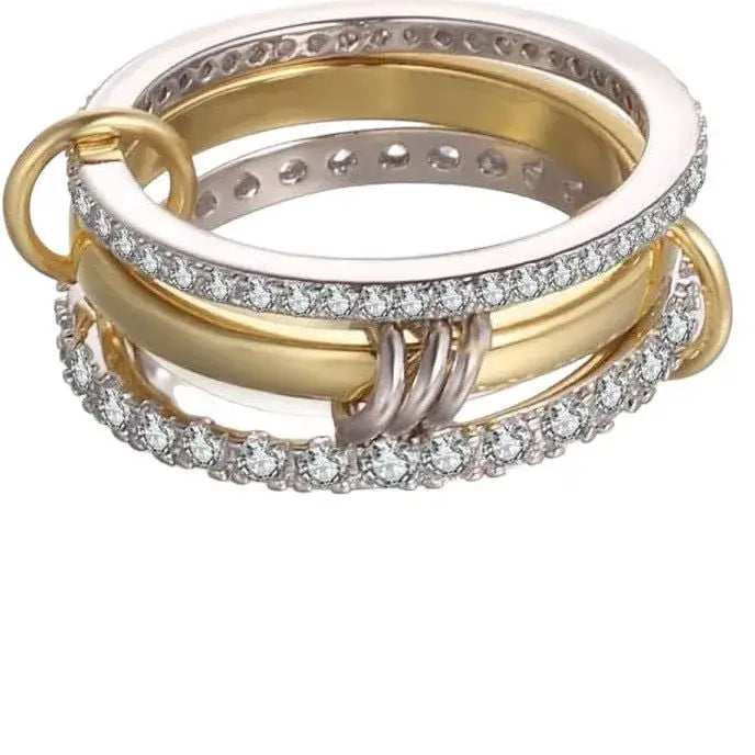 A multi-band ring set featuring yellow gold, white gold, and silver bands, some adorned with pavé diamonds and others with textured inner detailing, shown on a plain white background.