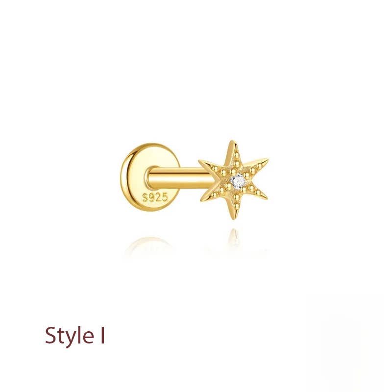A gold-colored labret stud earring featuring a five-pointed star with a small clear central gemstone, shown from the side on a white background with a faint reflection. The text 'Style I' is printed in brown in the bottom-left corner, and 'S925' is stamped on the flat back post.